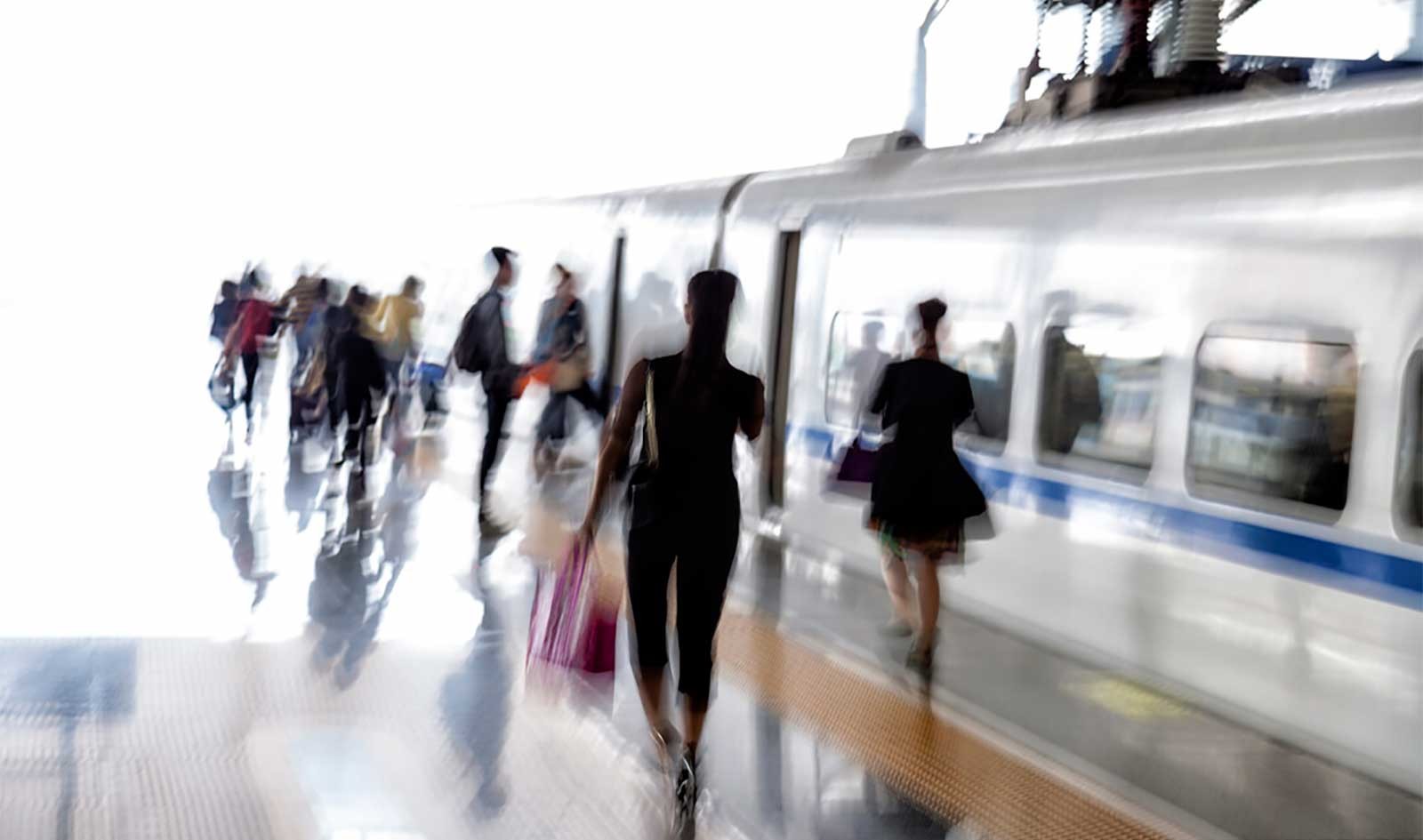 Blurred image of riders boarding train, photo by Dalia Leven