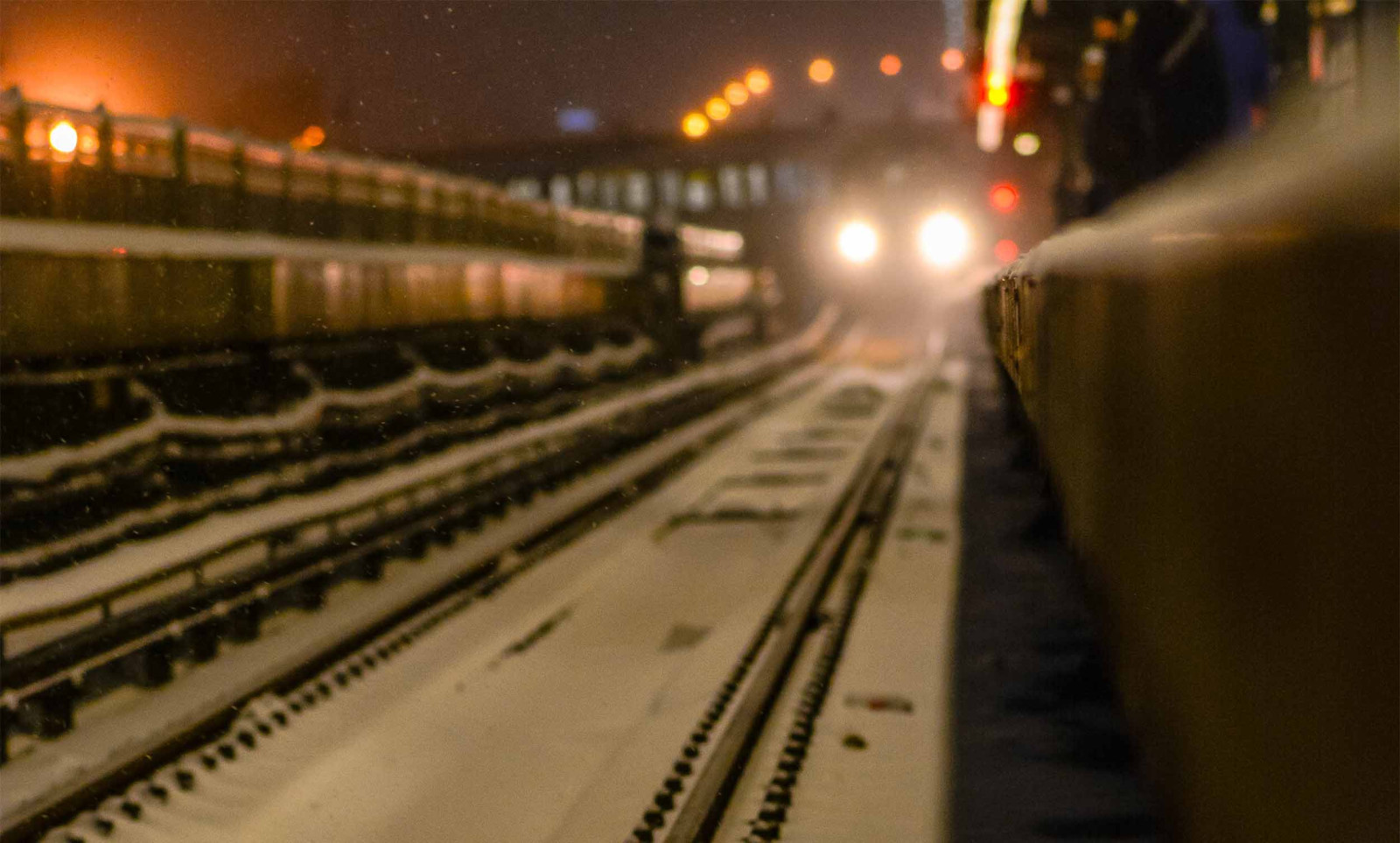 Image of incoming train on snowy tracks