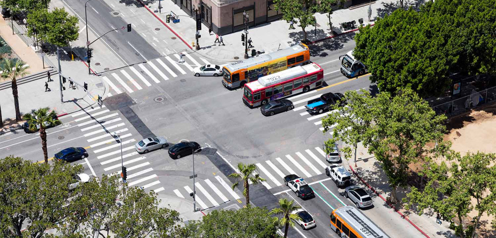 Aerial photo of busy LA intersection full of cars and transit buses.