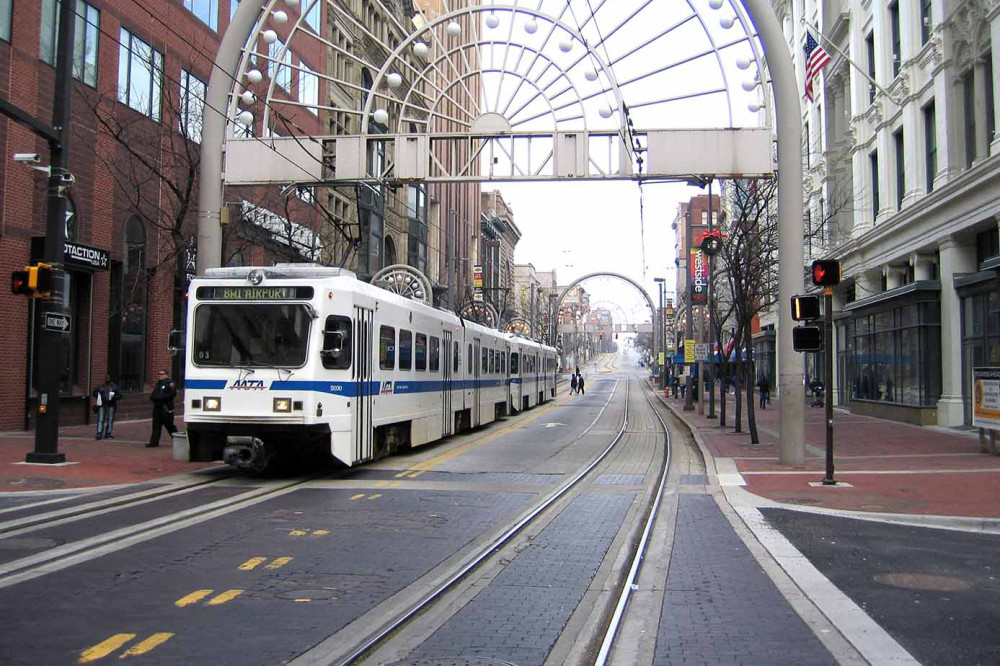 Photo of city street with light rail train headed to BWI airport