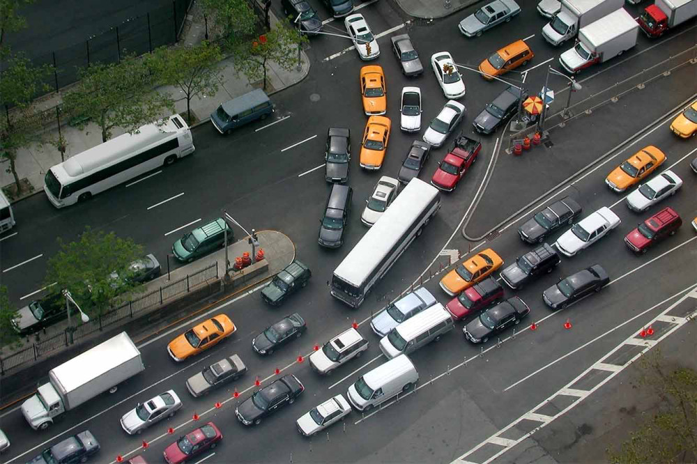 Aerial view of traffic in NYC containing cars, public transit, trucks, and cabs